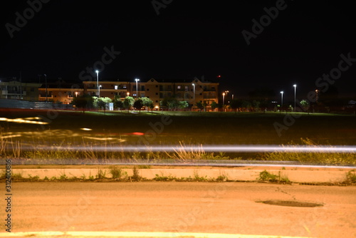Night Road Illuminated by lamps with Light Trails