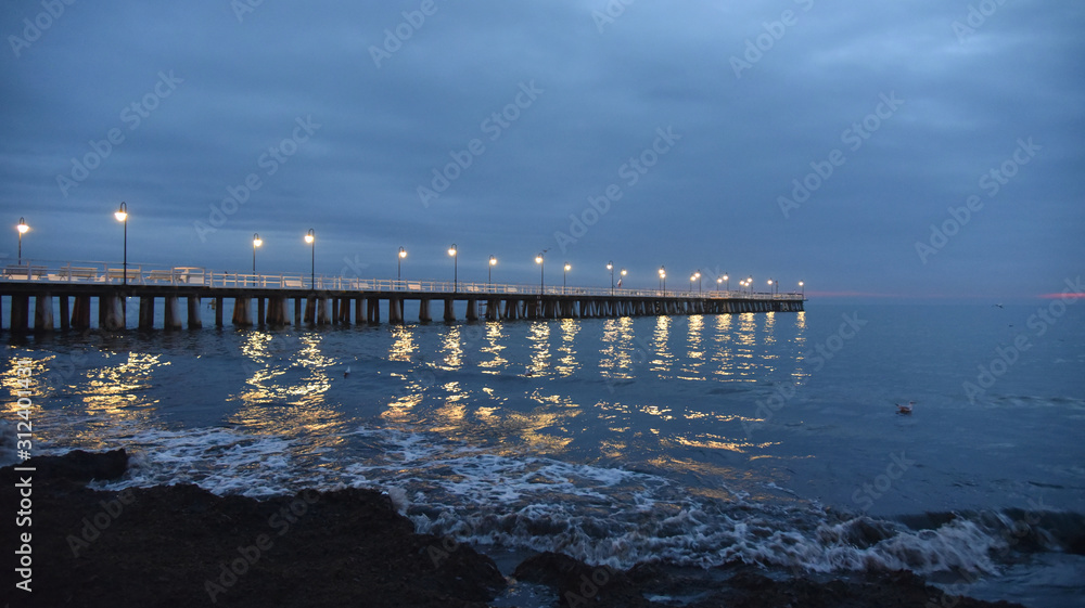Wooden pier in Gdynia Orlowo in the early morning, just before sunrise.
