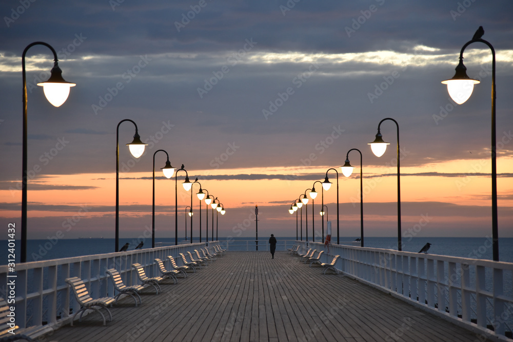 Wooden pier in Gdynia Orlowo in the early morning with colors of sunrise. Poland, Europe.