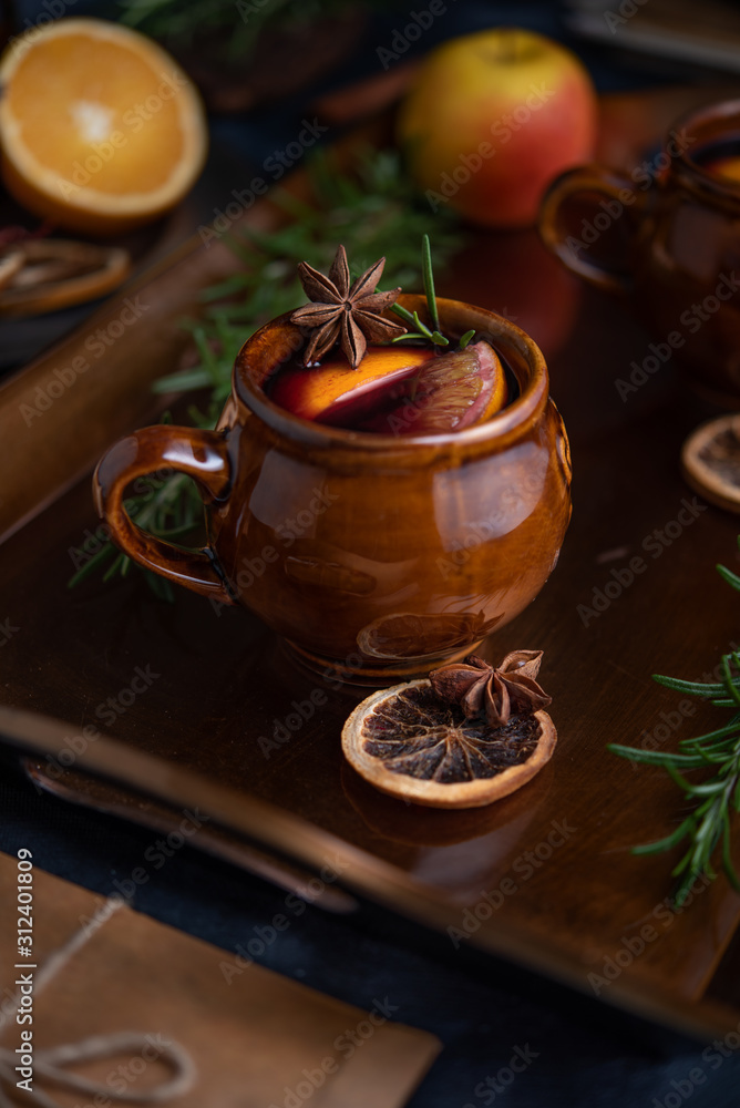 Warming mulled wine on dark background Warming mulled wine on dark background