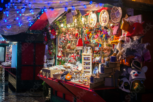 Stand with sweets at Christmas Market . Advent Fair Decoration and Stalls with Crafts Items on the Bazaar. © YarikL