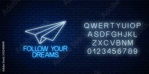Follow your dreams - glowing neon inscription phrase with paper airplane with alphabet. Motivation quote in neon style.
