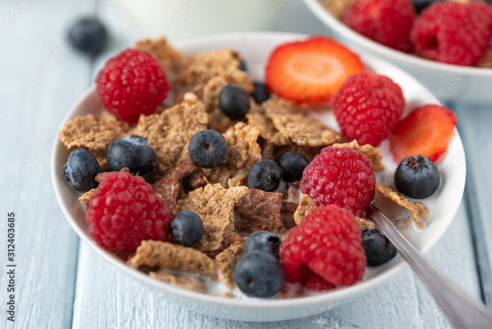 Healthy breakfast of granola chips with blueberries, raspberries and strawberries on white desk. Healthy breakfast of granola chips with blueberries, raspberries and strawberries on white desk.