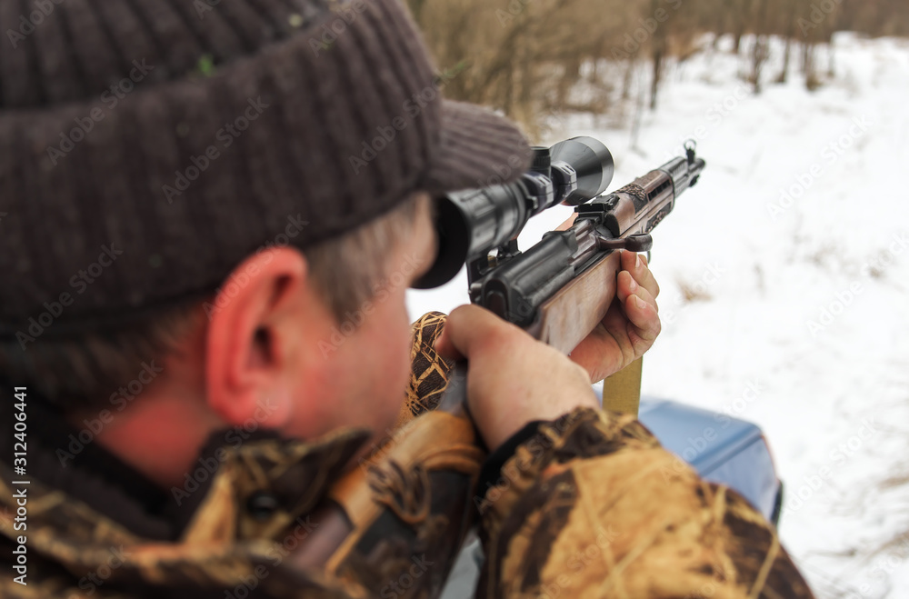 Winter hunting. Hunter moving With rifle and Looking For Prey. Winter hunting. Hunter moving With rifle and Looking For Prey.