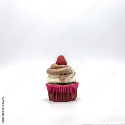 chocolate cupcake with frosting and raspberry garnish