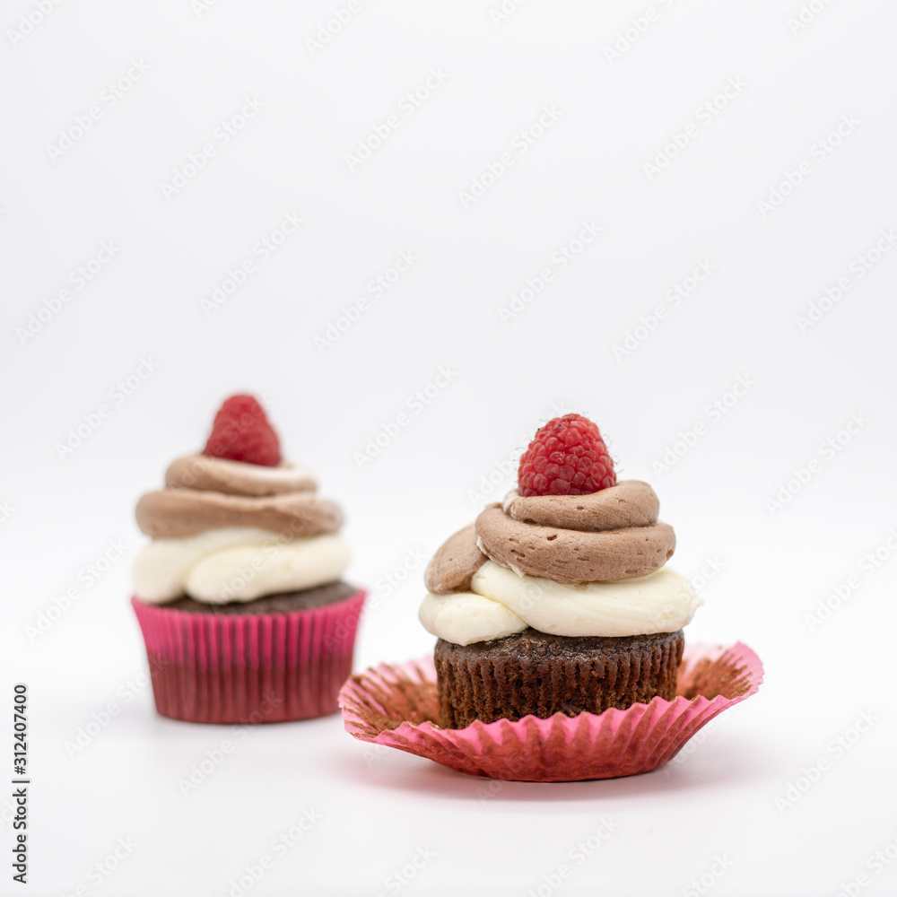 chocolate cupcake with frosting and raspberry garnish