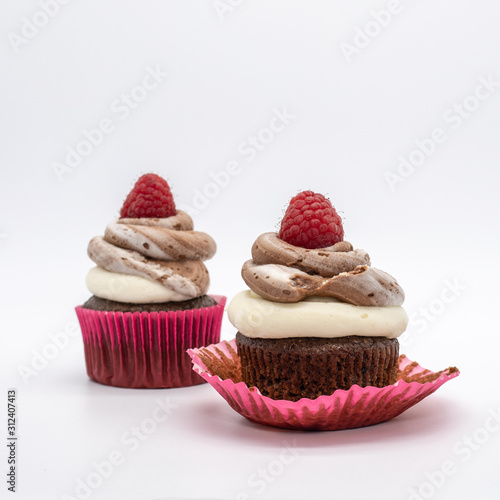 chocolate cupcake with frosting and raspberry garnish