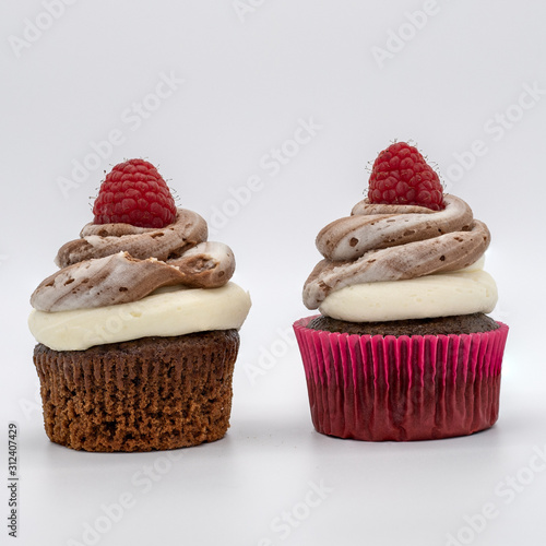 chocolate cupcake with frosting and raspberry garnish