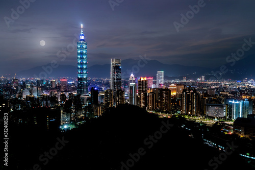 Full moon city skyline  with  taipei 101 tower in taiwan  skyscraper buildings night sky