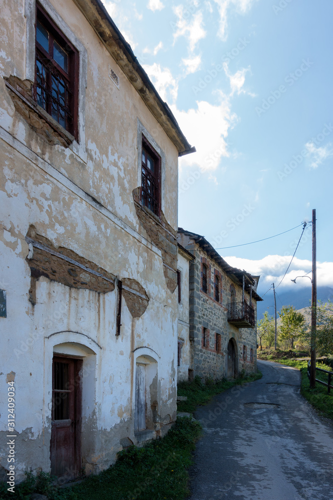 Street with old houses in Akritas village, Florina, Greece 