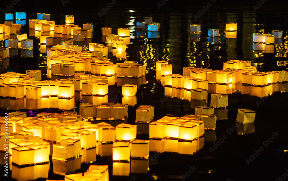 Traditional asian floating water lanterns on the lake during New Year's winter celebration in Tilburg, Netherlands