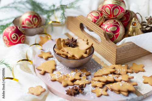 Christmas and New Year cookies in shape of christmas tree and star and baubles in wooden tray. Festive decoration
