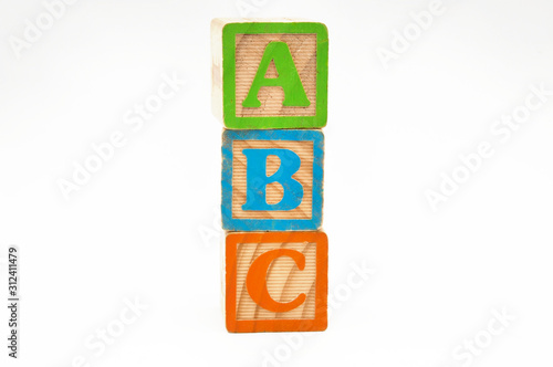 wooden cube blocks stacked with the letters abc isolated on a white background