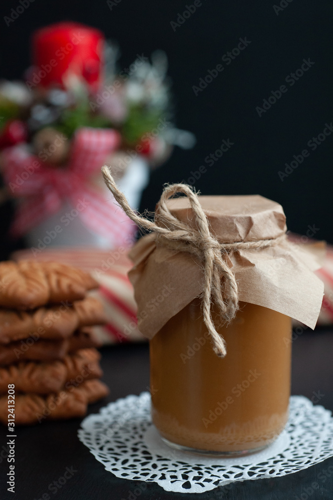 jar of salty caramel with Christmas gifts with New Year's composition jar of salty caramel with Christmas gifts with New Year's composition
