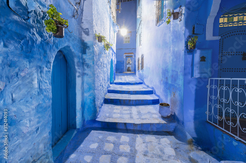 Traditional and typical moroccan architectural details in Chefchaouen, Morocco Africa Narrow and beautiful street of blue medina with blue walls and decorated with various objects. Nice doors, windows © Michal
