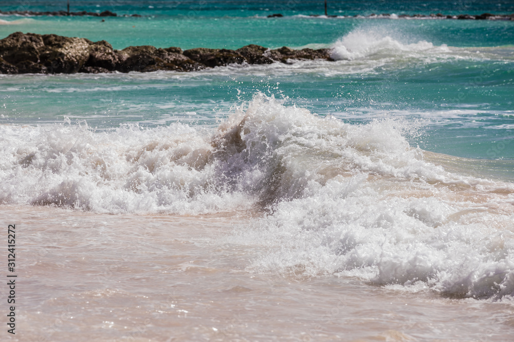 Fototapeta premium Waves crashing on rocks on a beach