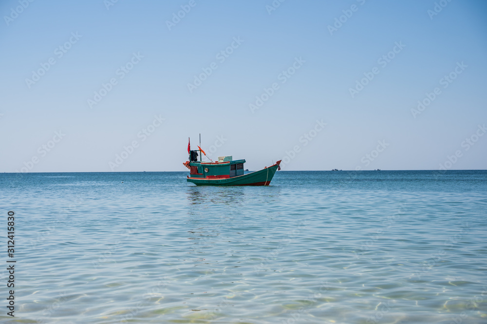 Wooden motor boat with a Vietnamese flag