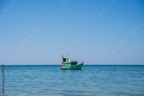 Wooden motor boat with a Vietnamese flag © carles