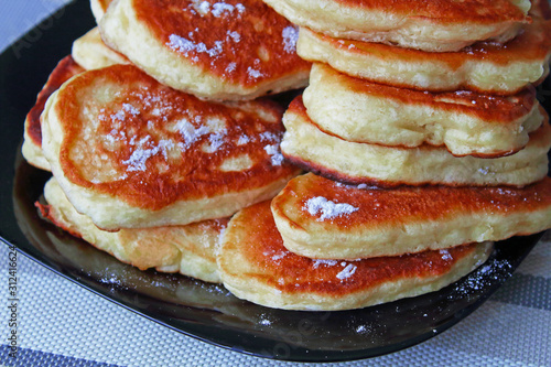 Fresh pancakes on a plate on the table. Close-up. Background.