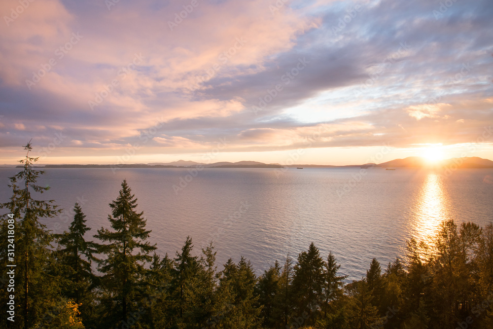 colorful sunset from cliff with a view over the sea forest and mountains , America near Seattle