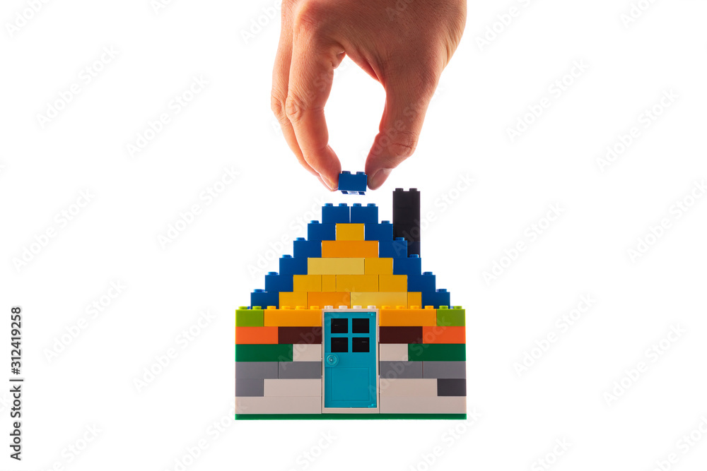 House made of classic building blocks, white studio background. House made of classic building blocks, white studio background.