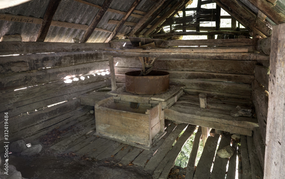 Interior of old water mill for grinding grain near Gârnic, Banat, Romania
