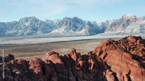 Aerial scenic shot of snow covered Red Rock Canyon mountains, sandstone cliffs
