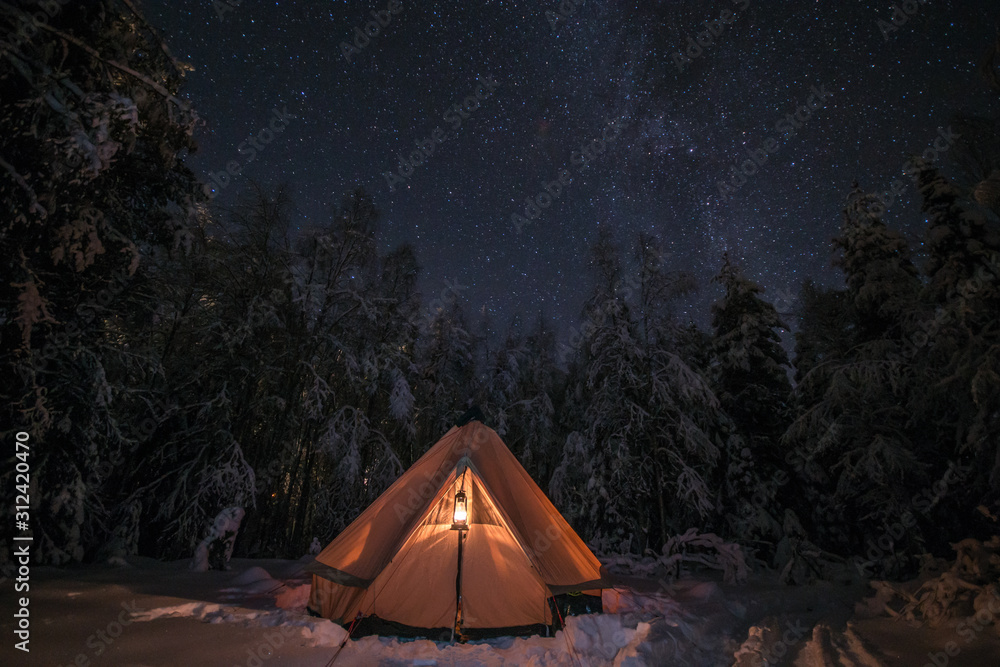 Romantic winter camping in the snowy forest
