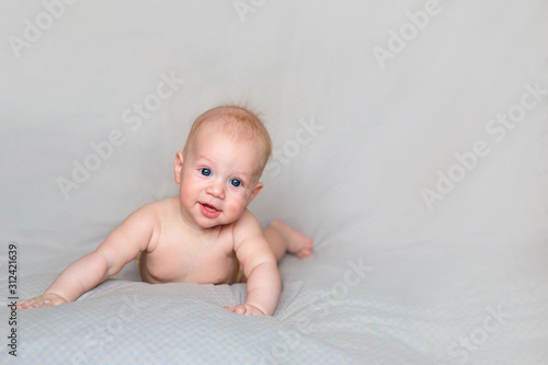 Cute little baby smiling and relaxing in bright bedroom. Nursery for little children	