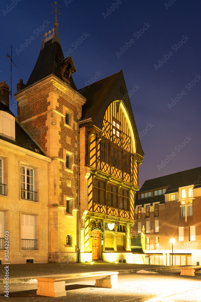 Pilgrim house illuminated at night by the Amiens cathedral in the historic center of Amiens, France