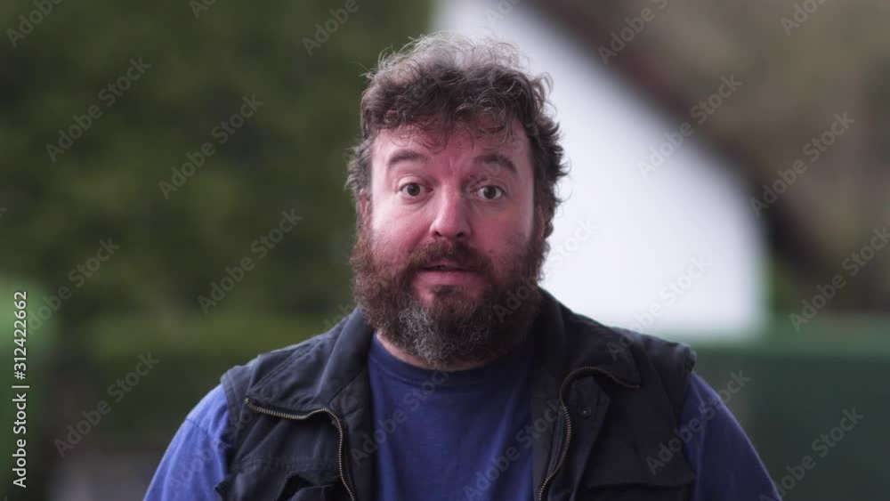 Bearded man is scared and prefers to put on a helmet. Concept idea Bearded man is scared and prefers to put on a helmet. Concept idea
