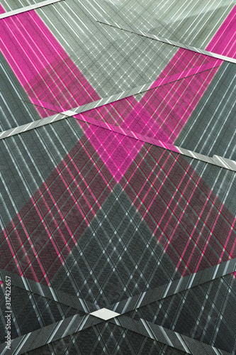 Digitally rendered image with polygonal structure of perforated panels. Abstract modern architecture background. Geometric pattern of parallel lines.