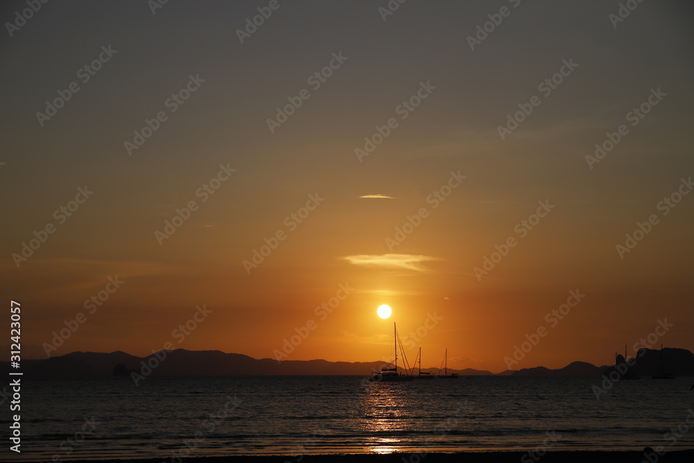 Sunset in the beach with a boat, Thailand 