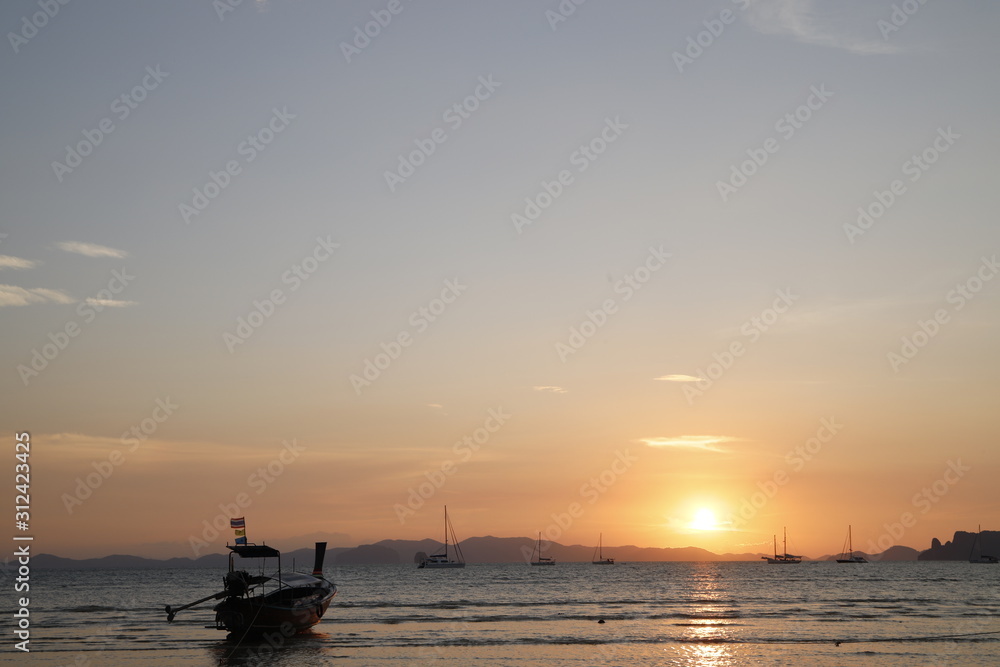Sunset in the beach with a boat, Thailand 