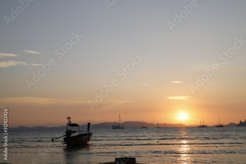 Sunset in the beach with a boat, Thailand  © Ricardo