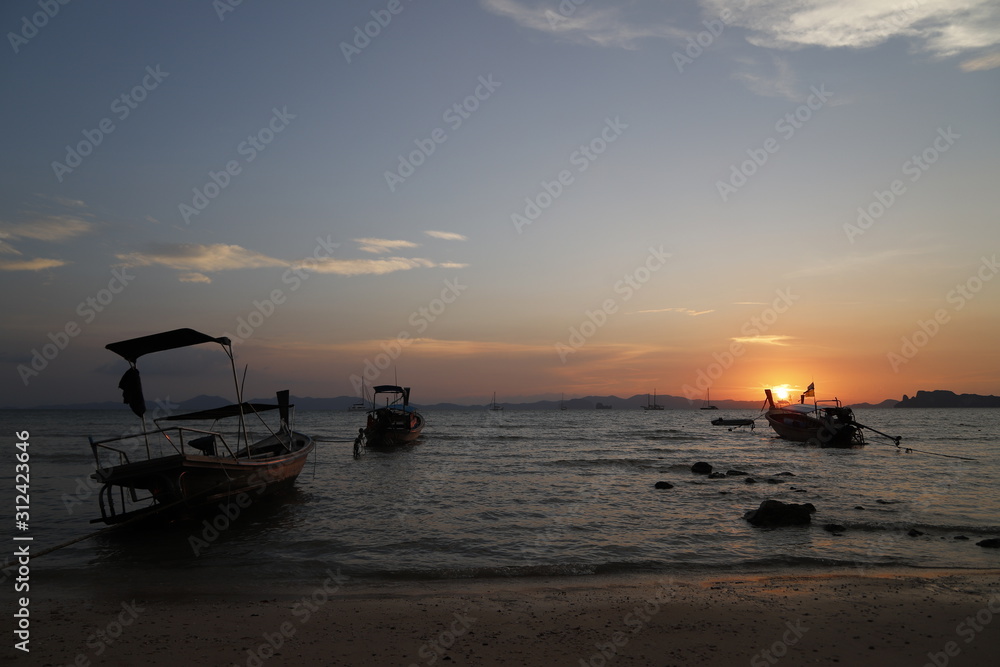 Sunset in the beach with a boat, Thailand 