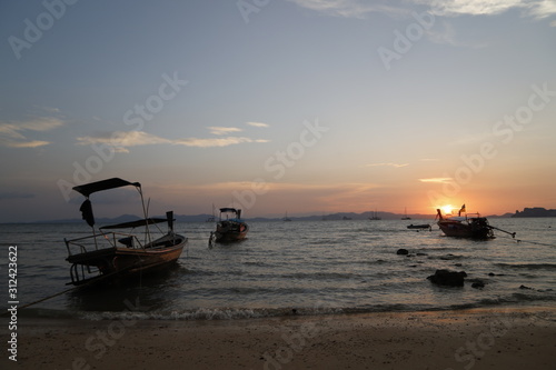 Sunset in the beach with a boat, Thailand  © Ricardo