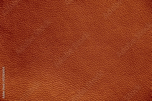 The texture of genuine leather. Impeccable and stylish background. Beautiful stylish background. Natural skin texture close up. Brown background. The structure of the leather material brown shades