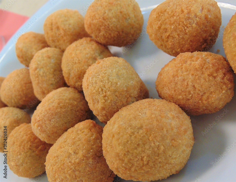 Fried mozzarella cheese balls (mozarella fritta) on a white plate, close-up. Traditional Italian cuisine. Fried mozzarella cheese balls (mozarella fritta) on a white plate, close-up. Traditional Italian cuisine.