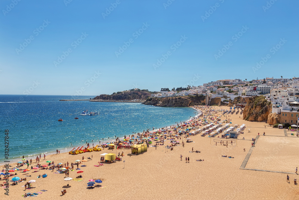 Famous tourist beach with fishermen in Albufeira, Portugal.