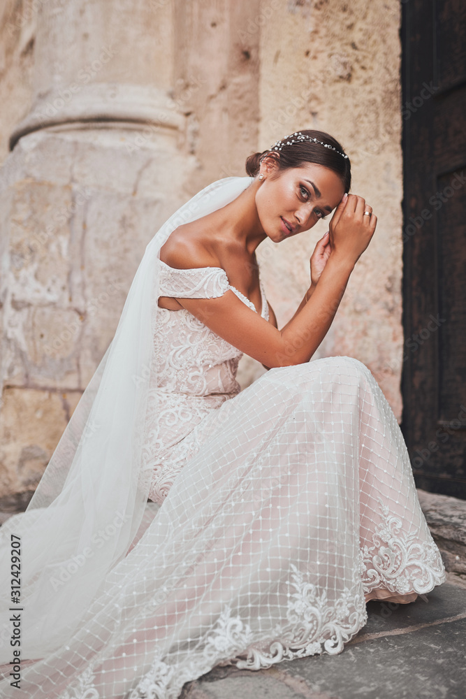 Bride in wedding dress on background of old european city Bride in wedding dress on background of old european city