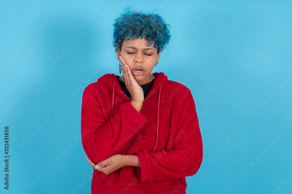 young woman or afro american girl isolated on blue background with expression young woman or afro american girl isolated on blue background with expression