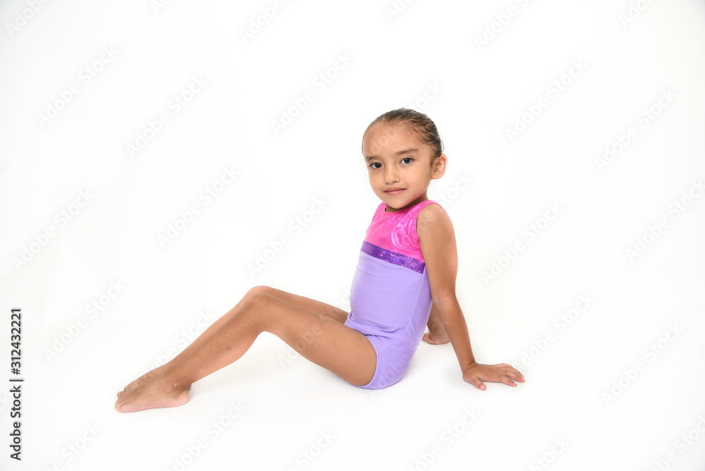 small latin girl doing gymnastics with white background and purple sportswear small latin girl doing gymnastics with white background and purple sportswear
