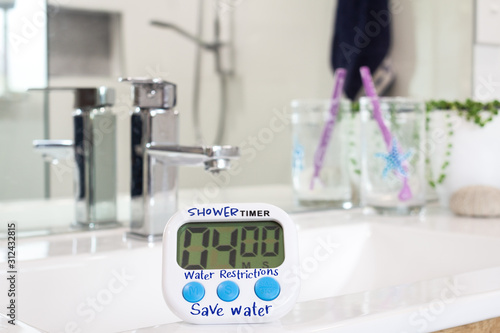 water restrictions, homemade shower timer in bathroom, used to limit shower duration due to water restrictions caused by drought conditions