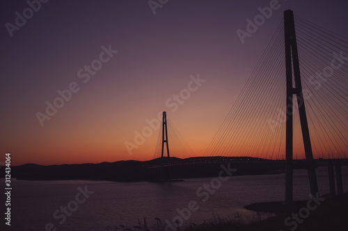 Sea landscape with a view of the Russian bridge at sunset.