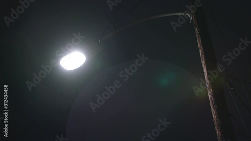 Street light at night during a light rain