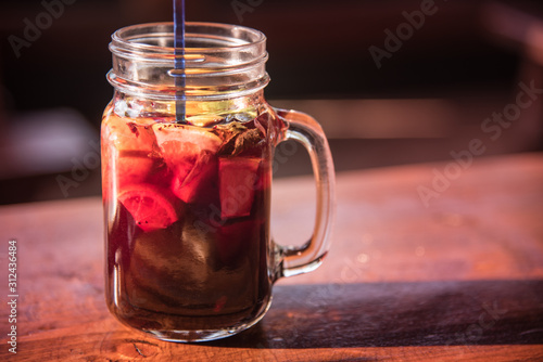 Healthy yummy home made fruit drink with mountain blueberries, oranges, grapefruit lemon and mint in vintage jar glass