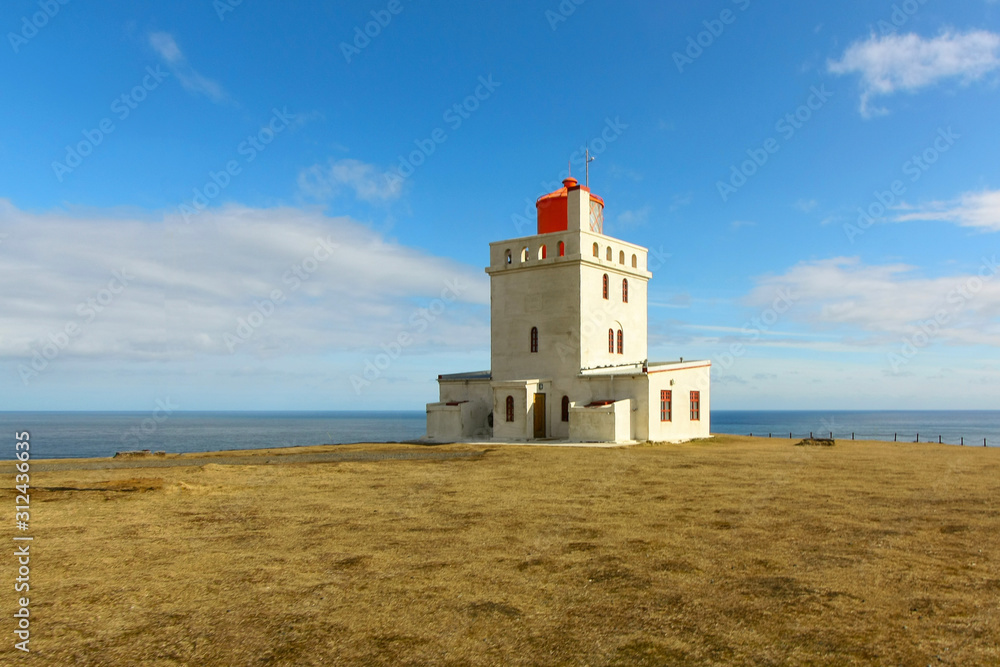 White lighthouse against a cold Atlantic ocean