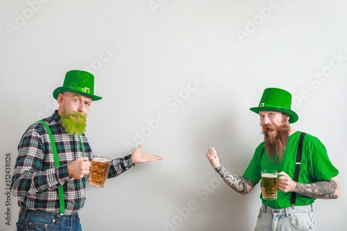 Bearded men with glasses of...