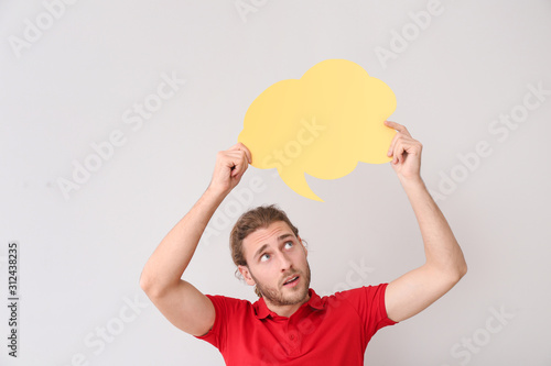 Young man with blank speech...